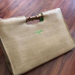 BUZZ by Jane Fox Bamboo handle woven rattan bag.